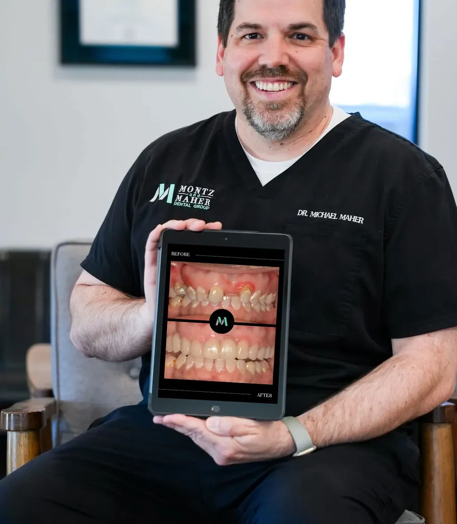 Dr. Michael Maher seated in the office, holding a tablet that shows one of his patient's before and after photographs.