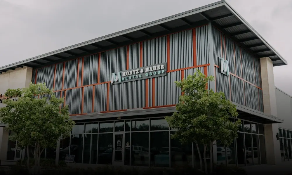 The Montz & Maher Friendswood office, a two-storey building with the practice sign above the glass frontage.